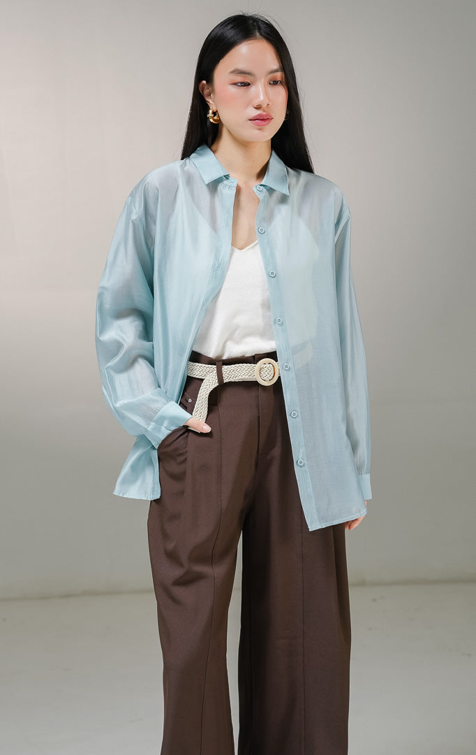 Kemeja lengan panjang wanita This Is April Favino Top warna biru mint, model oversized shirt dengan material kain sheer transparan halus yang menerawang dan detail kancing depan hidup.