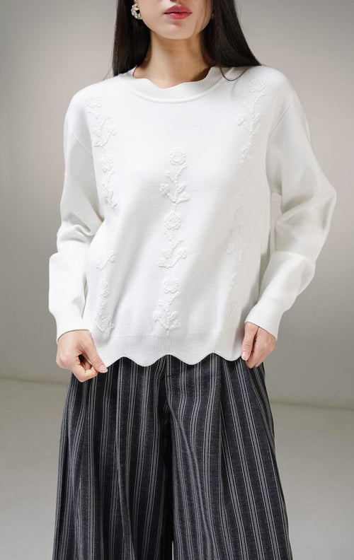 Atasan sweater rajut lengan panjang wanita This Is April Galina Sweater warna putih dengan detail tiga lajur motif bunga timbul (bertekstur) di bagian depan.