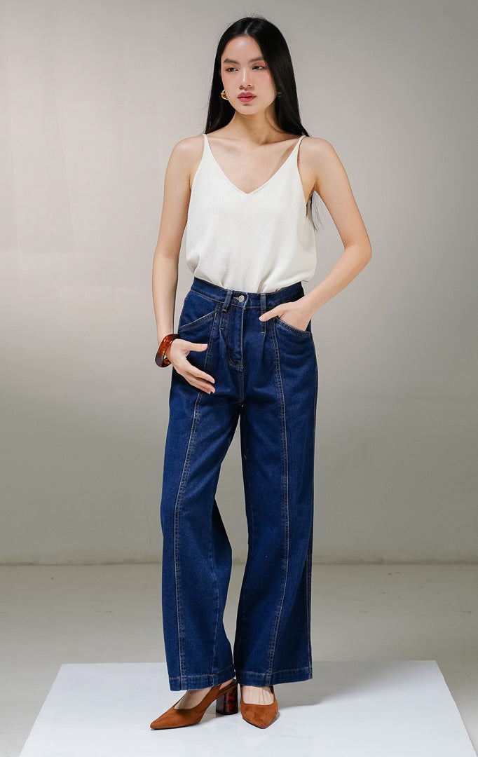 Celana panjang jeans wanita This Is April Gwen Pants warna dark denim (biru tua), model high-waist straight leg dengan detail saku samping depan dan aksen jahitan vertikal di bagian tengah kaki.