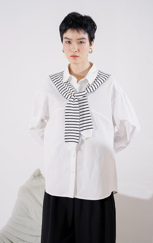 Kemeja wanita lengan panjang Krystal Top dari This Is April berwarna putih bersih berkerah klasik, dilengkapi dengan kancing depan dan aksen syal rajut motif garis hitam putih yang diikatkan di kerah 