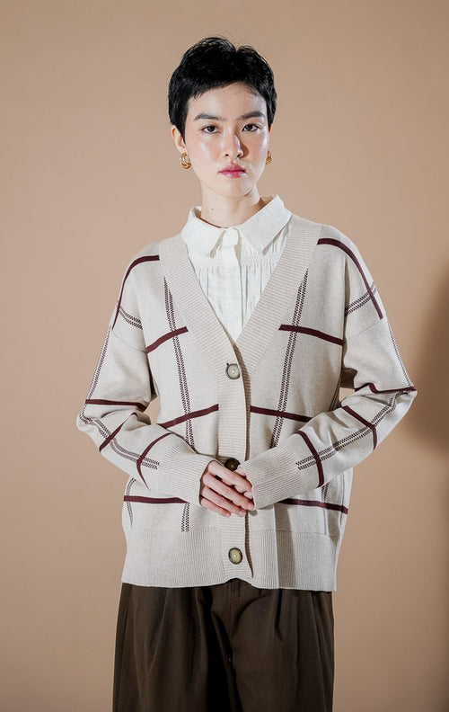 Thena Cardigan Khaki dari This Is April, cardigan rajut V-neck warna krem khaki dengan motif garis kotak-kotak cokelat marun dan kancing depan.