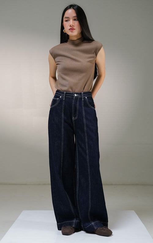 Celana panjang jeans wanita This Is April Toska Pants warna dark denim biru tua, model high-waist loose wide-leg dengan detail saku samping dan aksen benang jahitan kontras warna putih. 