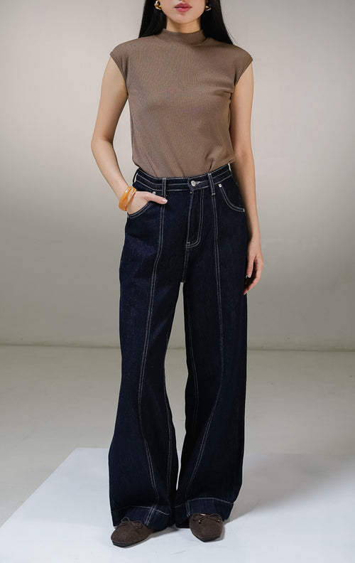 Celana panjang jeans wanita This Is April Toska Pants warna dark denim biru tua, model high-waist loose wide-leg dengan detail saku samping dan aksen benang jahitan kontras warna putih. 