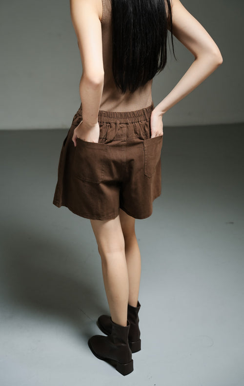Celana pendek wanita model tailord bahan katun twill warna cokelat tua (dark brown utilitarian cotton twill shorts) Alden Pants dengan detail side-slant yang khas serta kenyamanan maksimal. 