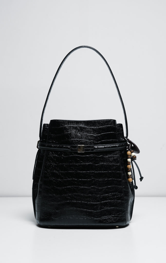 Tas wanita model bucket bag struktural bahan kulit warna hitam (black sculptural bucket bag) Edwardyne Bag dengan detail tali pegangan nyaman dan aksen perangkat keras yang modis. 