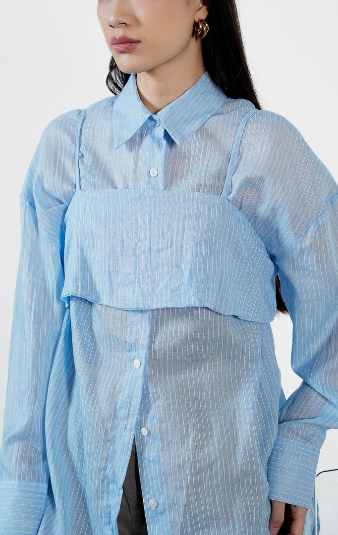 Pakaian wanita model kemeja lengan panjang motif garis vertikal halus dengan detail lapisan luar bralette (pinstripe bralette overlay shirt) warna biru Freya Top untuk gaya kasual modern yang trendi. 