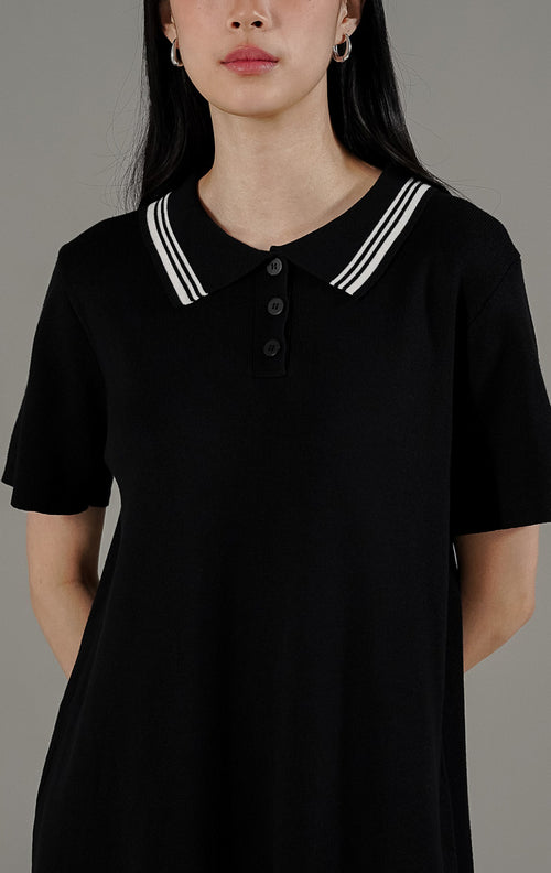  Iveta Dress Black dari This Is April, gaun rajut midi warna hitam dengan detail kerah polo garis putih dan kancing depan aktif.