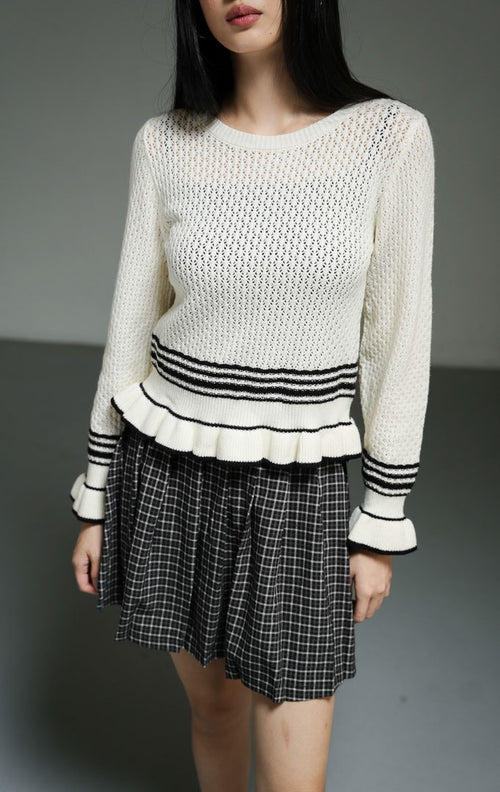 Cardigan rajut wanita lengan panjang warna putih gading (ivory ruffle-hem knit cardigan) Laurent Cardigan dengan detail ruffle halus di bagian lengan dan hem, aksen garis hitam, serta bahan rajut elastis yang nyaman untuk pelapis (layering).