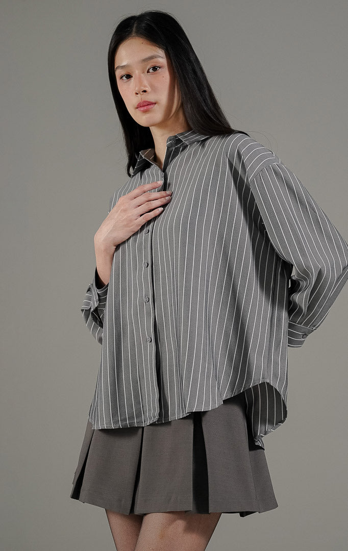 Nerisse Top Dark Grey dari This Is April, kemeja kancing depan motif salur vertikal abu abu tua dengan potongan bahu turun.