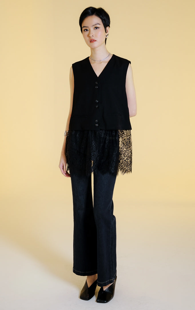 Pakaian rompi wanita tanpa lengan kerah V kancing depan dengan aksen renda bunga transparan di bagian bawah (floral lace hem vest) warna hitam Orvella Vest untuk gaya kantor dan kasual anggun. 

