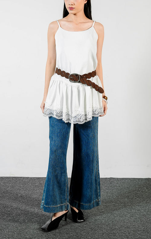 Pakaian wanita model atasan kamisol tali spageti bahan poliester dengan detail lapisan bertingkat dan aksen renda di bagian bawah (tiered flounce hem camisole top) warna putih Velicia Top untuk gaya kasual feminin. 